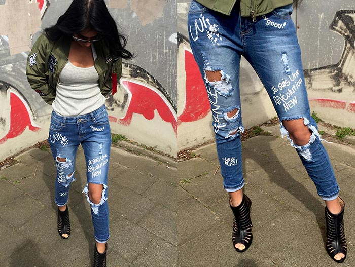 Gescheurde broek jeans met gaten en verf teksten. Ga voor een stoere gescheurde jeans voor de lente van 2016 een echte musthave.